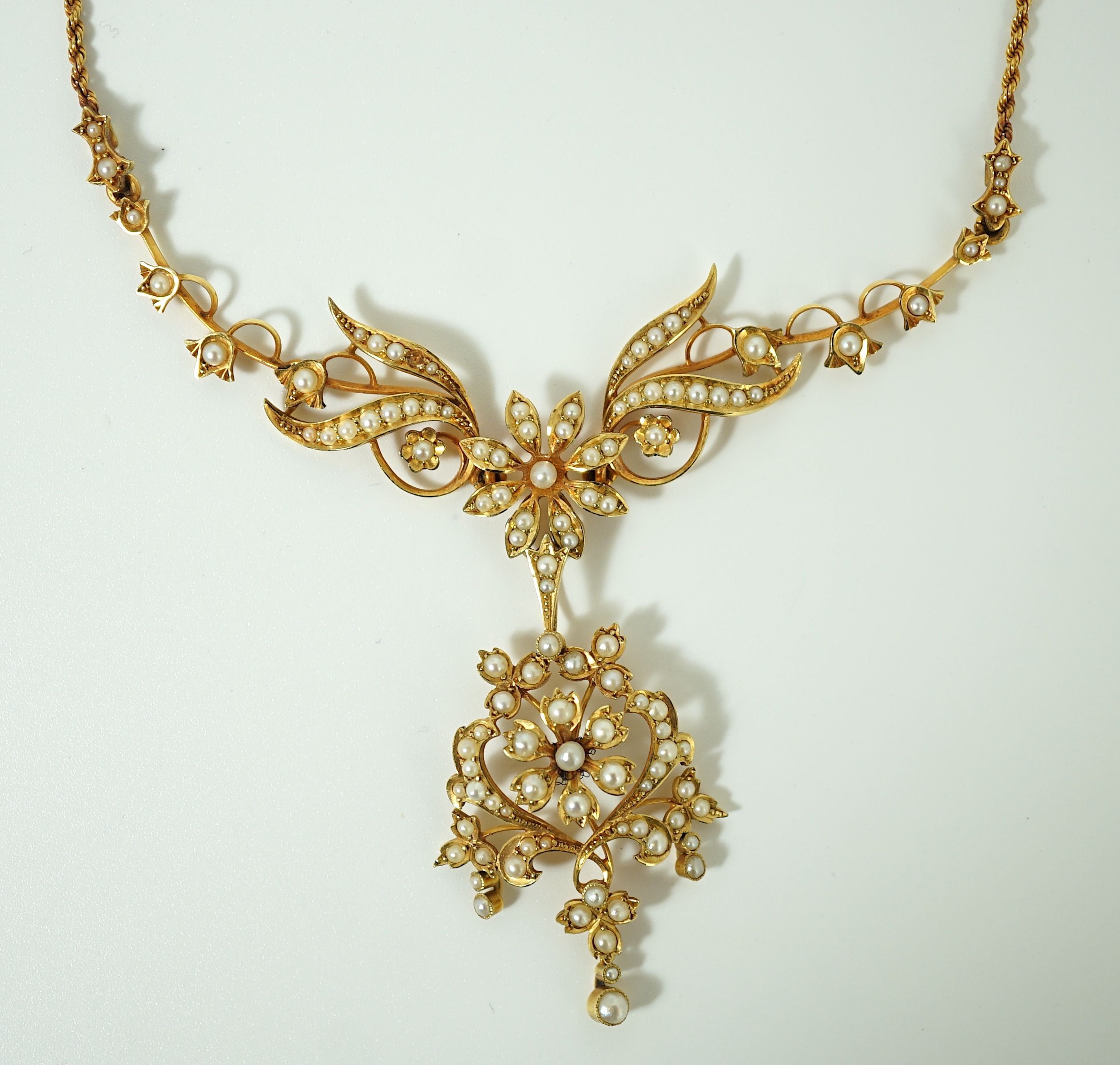 A late Victorian 15ct gold and seed pearl set drop pendant necklace
